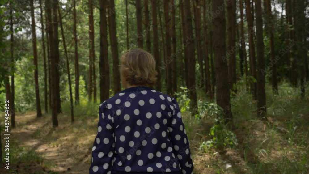 Senior woman walking around sentimental young days places, thinking about the most memorable moments of her life passed. Walking in the park near river. Senior woman walking around sentimental young days places, thinking about the most memorable moments of her life passed. Walking in the park near river.