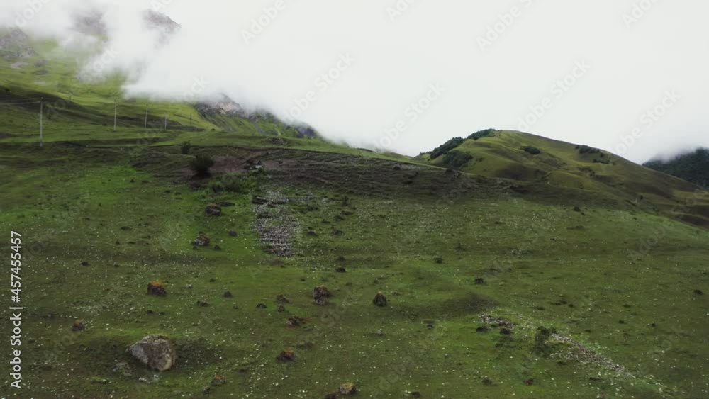 The Caucasus. Mountain slopes, overgrown with grass and strewn with large stones The Caucasus. Mountain slopes, overgrown with grass and strewn with large stones