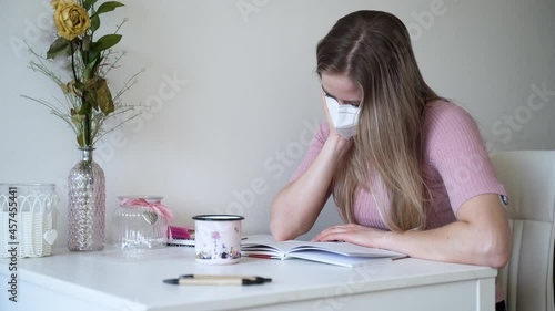 A young girl reads a letter from her lover in her apartment. Distance relationship. photo