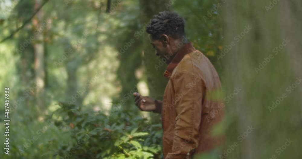 Homeless man receiving a cigarette and smiling while standing in a green park Homeless man receiving a cigarette and smiling while standing in a green park