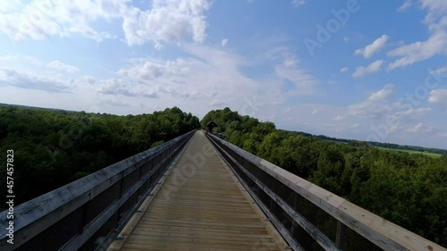 lady rides bike across high bridge in farmville virginia photo