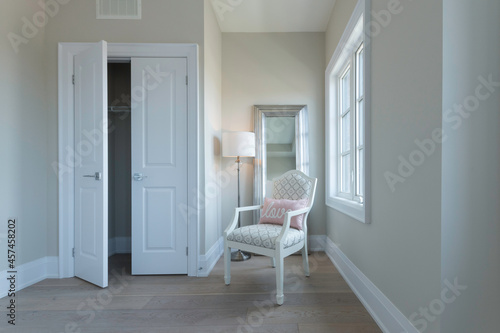 Bright Room with Chair Mirror and Floor Lamp open closet door