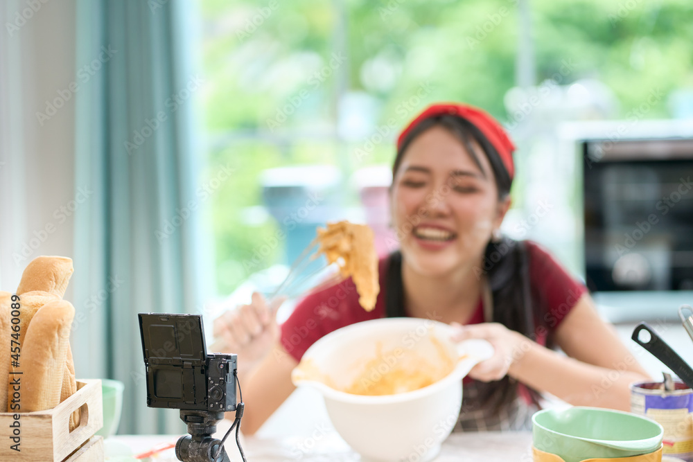 Focus on camera for bakery online class with asian young female teach cooking egg in bowl