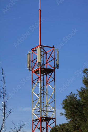 telecommunications tower of different mobile phone, radio and television operators with masts and microwave radio link antennas, 4g and deployment of 5g generation in cities and rural areas  photo