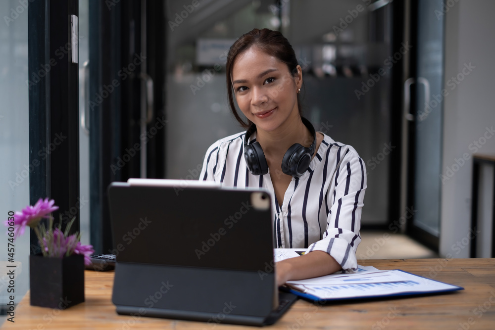Photo of gorgeous secretary working at office. she sitting at the wooden desk Photo of gorgeous secretary working at office. she sitting at the wooden desk
