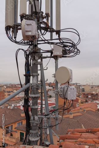 telecommunications tower of different mobile phone, radio and television operators with masts and microwave radio link antennas, 4g and deployment of 5g generation in cities and rural areas  photo