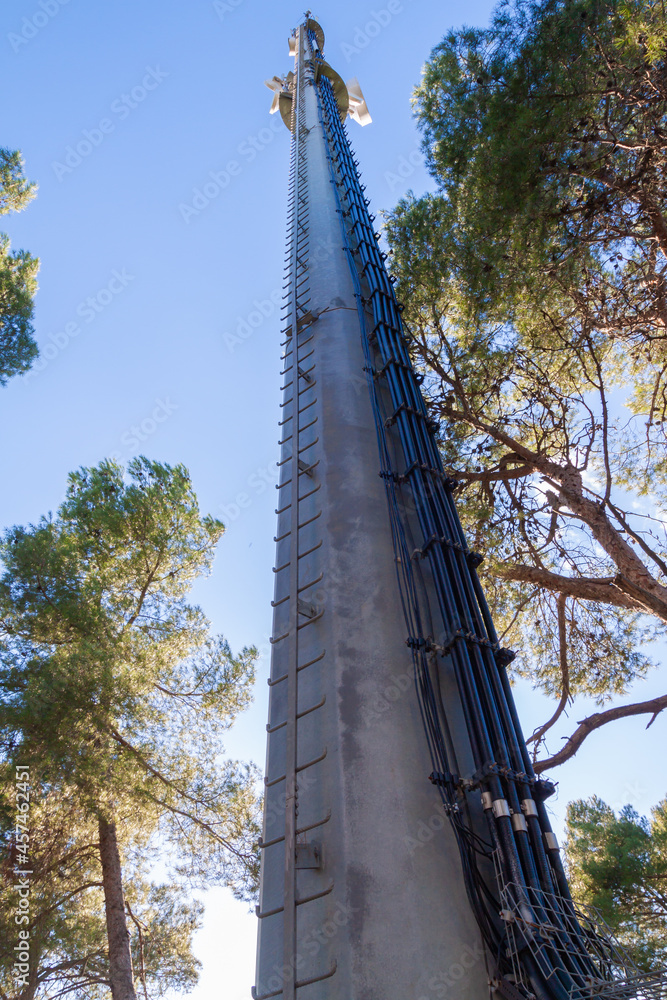 telecommunications tower of different mobile phone, radio and television operators with masts and microwave radio link antennas, 4g and deployment of 5g generation in cities and rural areas telecommunications tower of different mobile phone, radio and television operators with masts and microwave radio link antennas, 4g and deployment of 5g generation in cities and rural areas