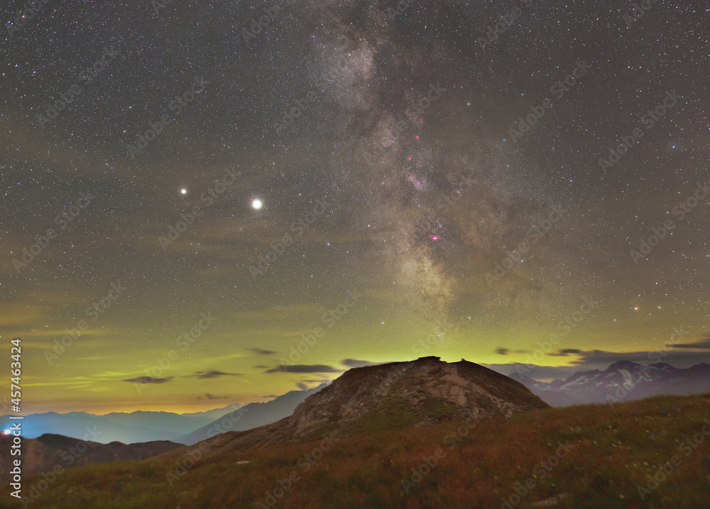 Milky Way over Alps with Jupiter, Saturn and magenta nebulaes
