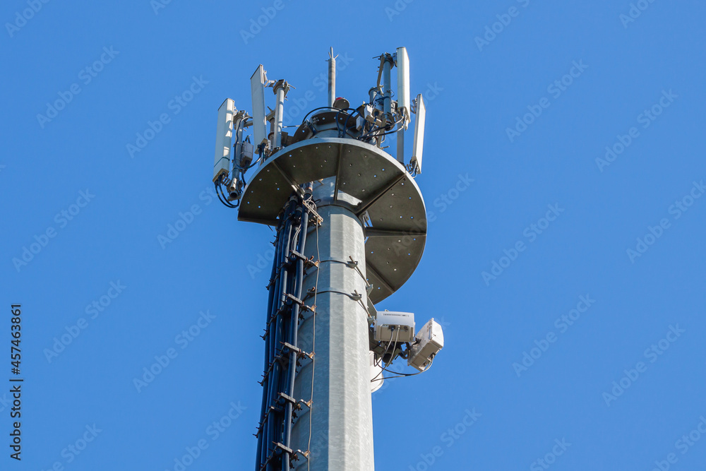 telecommunications tower of different mobile phone, radio and television operators with masts and microwave radio link antennas, 4g and deployment of 5g generation in cities and rural areas