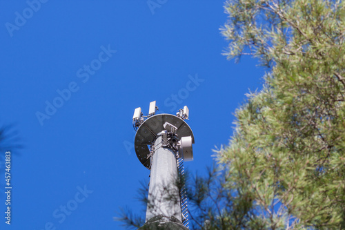 telecommunications tower of different mobile phone, radio and television operators with masts and microwave radio link antennas, 4g and deployment of 5g generation in cities and rural areas