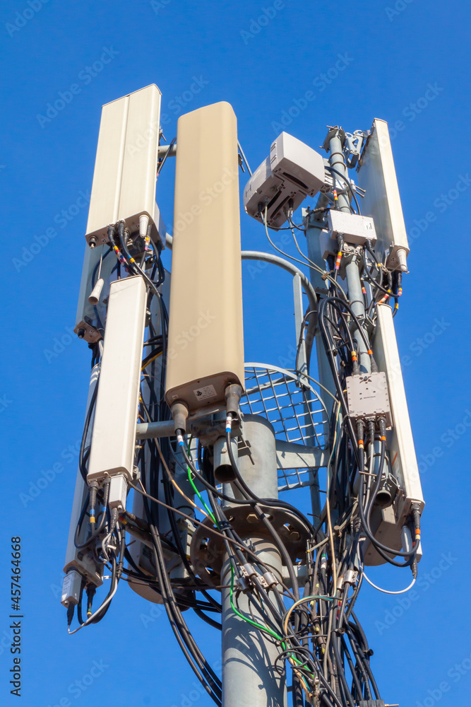 telecommunications tower of different mobile phone, radio and television operators with masts and microwave radio link antennas, 4g and deployment of 5g generation in cities and rural areas
