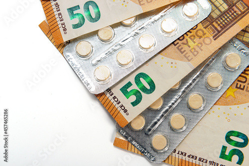 tablets in blister and fifty euro bills isolated on white, expensive healtcare concept