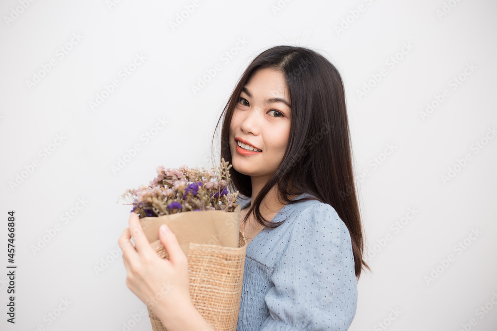 Beautiful happy smiling woman holding dried flowers bouquet Beautiful happy smiling woman holding dried flowers bouquet