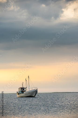 fishing boat on the sea at sunset, sunset by the sea with boat © Rauno