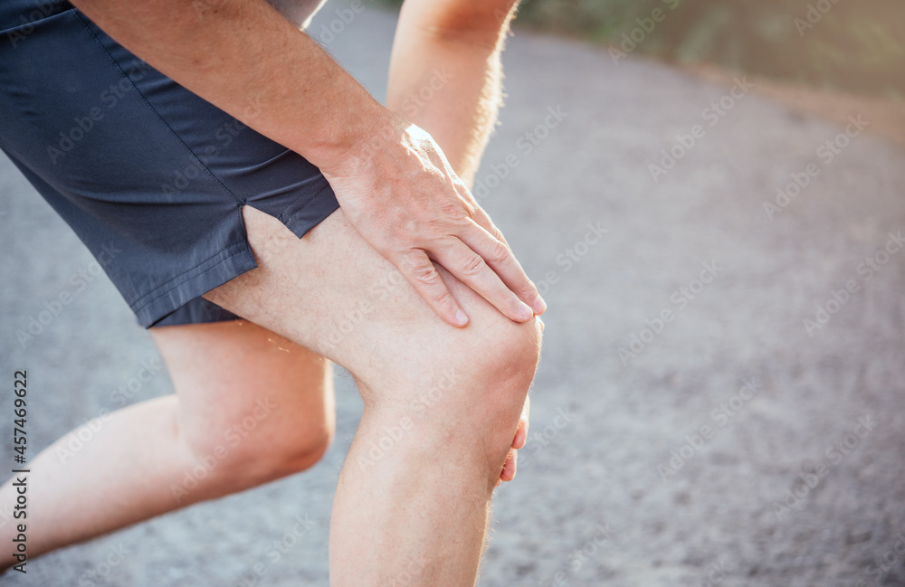 Sports fitness man suffer from knee pain when running or jogging