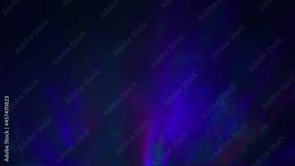 Neon multicolored beams rotate in smoke on a black background. Abstract light motion titles. Cinematic background. Neon multicolored beams rotate in smoke on a black background. Abstract light motion titles. Cinematic background.