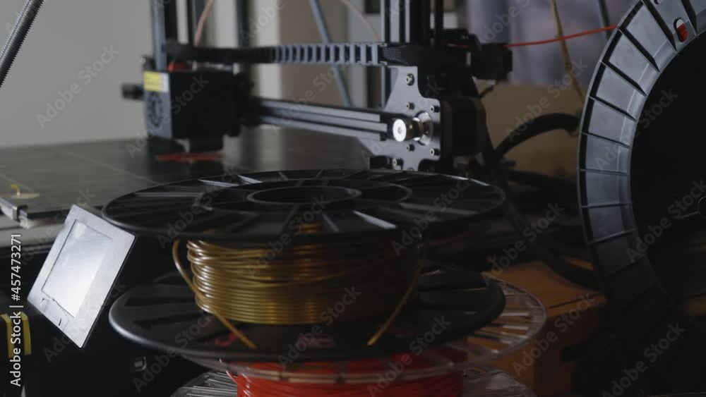 3D printer working close-up. High-tech fast printing of bulk plastic parts with heated polymer materials. Machine creates a modern prototype object 3D printer working close-up. High-tech fast printing of bulk plastic parts with heated polymer materials. Machine creates a modern prototype object