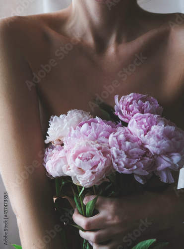 young woman with pink peonies