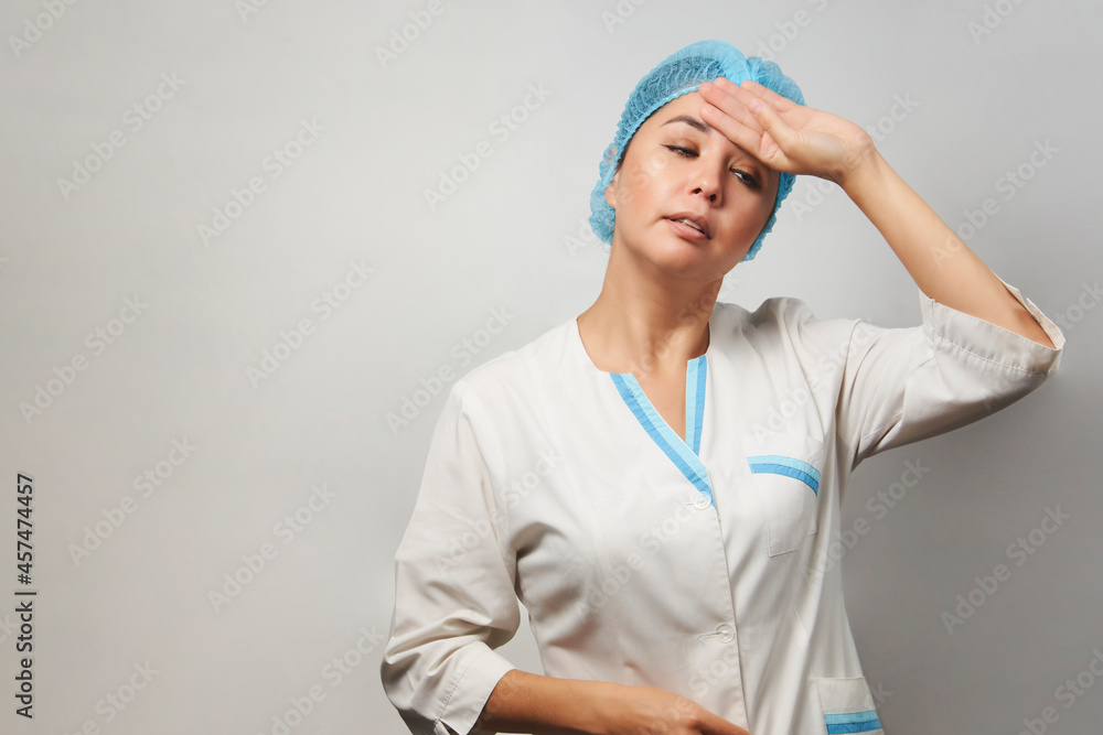 Exhausted female doctor having headache Exhausted female doctor having headache