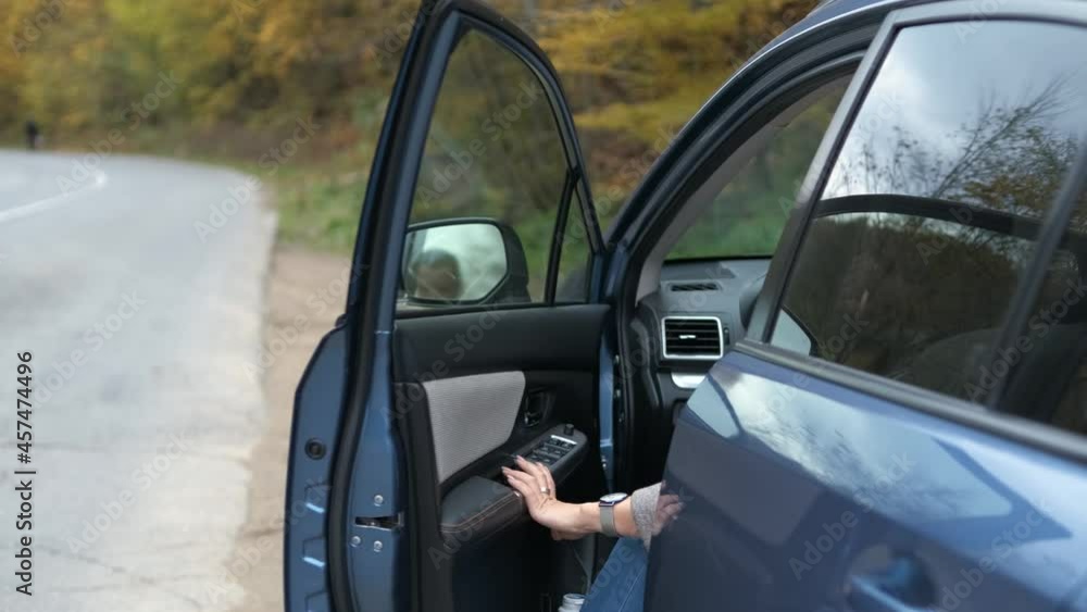 Middle aged pretty woman enjoying her time near car outdoors during road trip. Middle aged pretty woman enjoying her time near car outdoors during road trip.