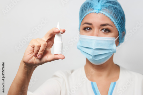 Female doctor with a nose spray or nasal drops