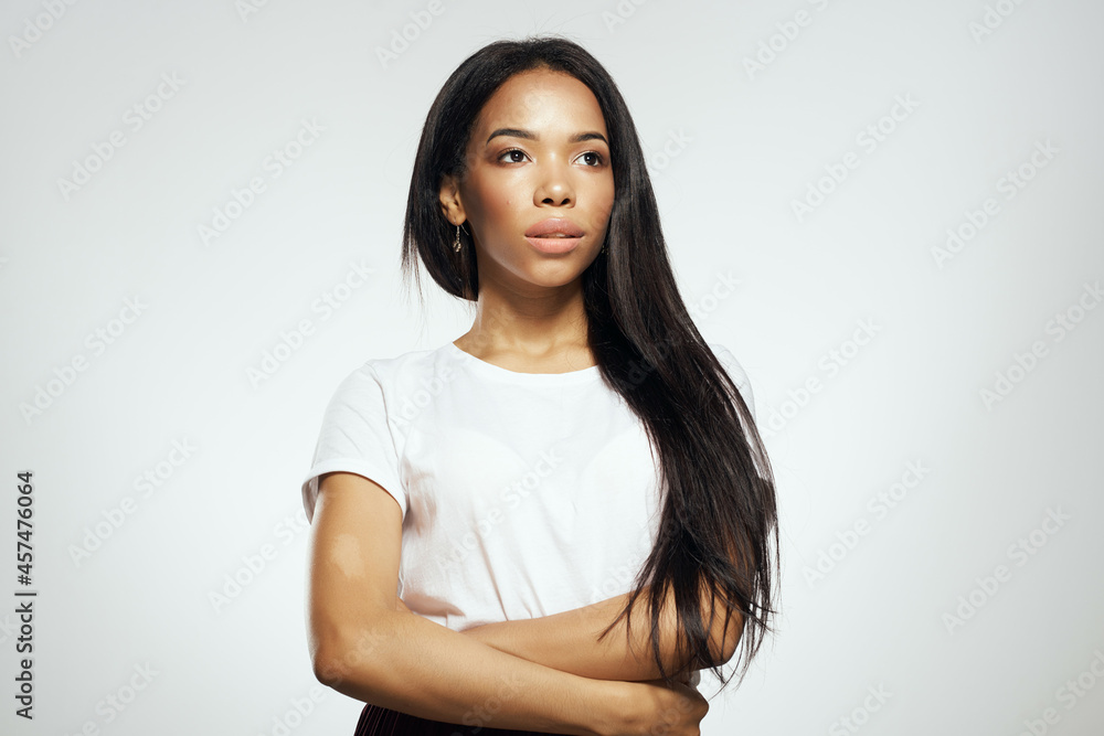 pretty woman of african appearance in t-shirt fashionable hairstyle light background pretty woman of african appearance in t-shirt fashionable hairstyle light background