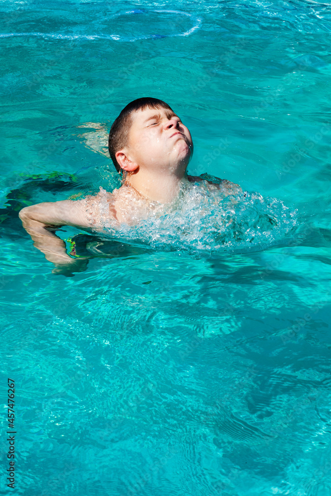 boy swimming in blue swimming pool