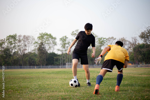 Sports and recreation concept two male soccer players attending regular practice sessions and memorizing attack and defense patterns