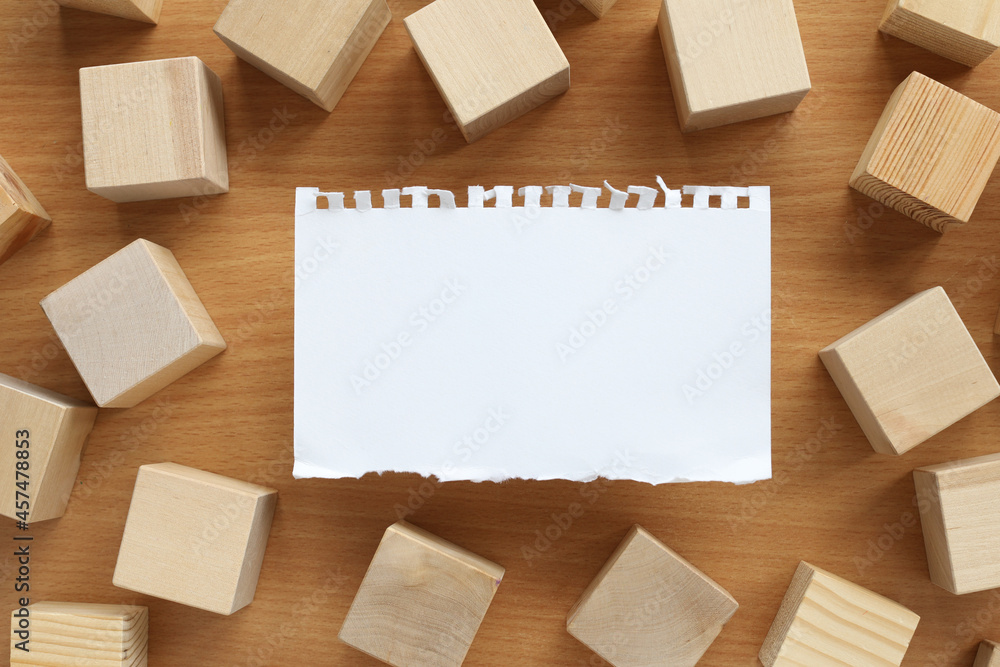 torn paper on a wooden background. with place for text. wood blocks torn paper on a wooden background. with place for text. wood blocks