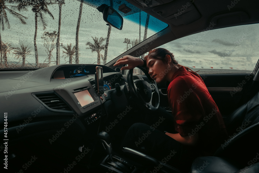 asian woman sleeping in car, attractive girl sitting in automobile, outdoors raining. lifestyle and people concept. asian woman sleeping in car, attractive girl sitting in automobile, outdoors raining. lifestyle and people concept.
