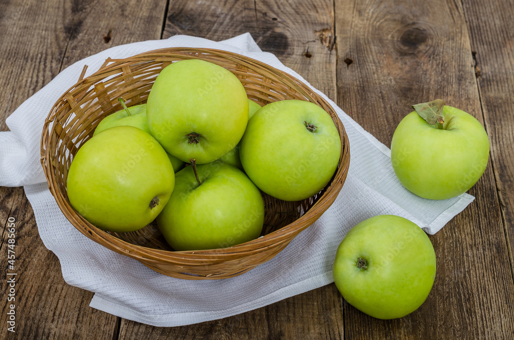 Ripe green apples in a wicker bowl Ripe green apples in a wicker bowl