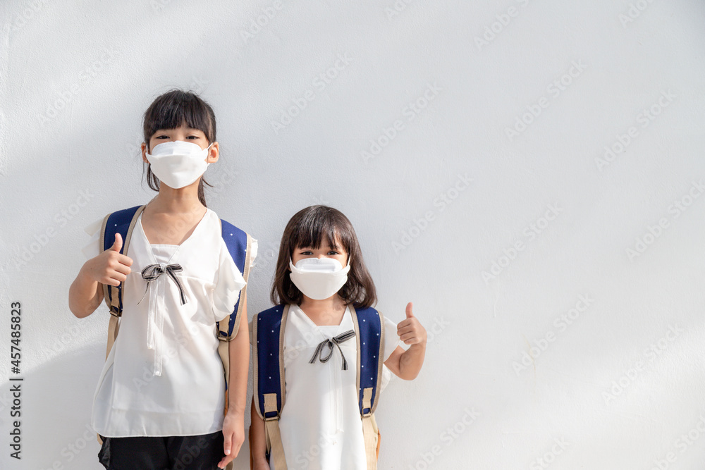 Sibling little girl wearing a mask to stop coronavirus outbreak.quarantine Asian sibling.covid-19 coronavirus and pandemic virus symptoms. Sibling little girl wearing a mask to stop coronavirus outbreak.quarantine Asian sibling.covid-19 coronavirus and pandemic virus symptoms.