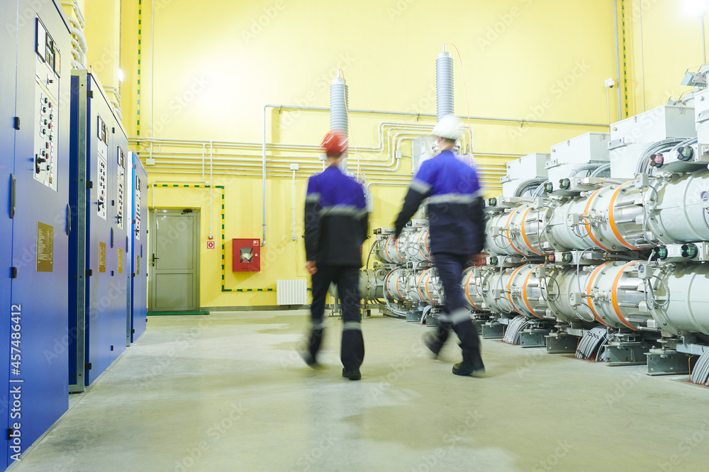 industrial technicians walks at power energy supply factory