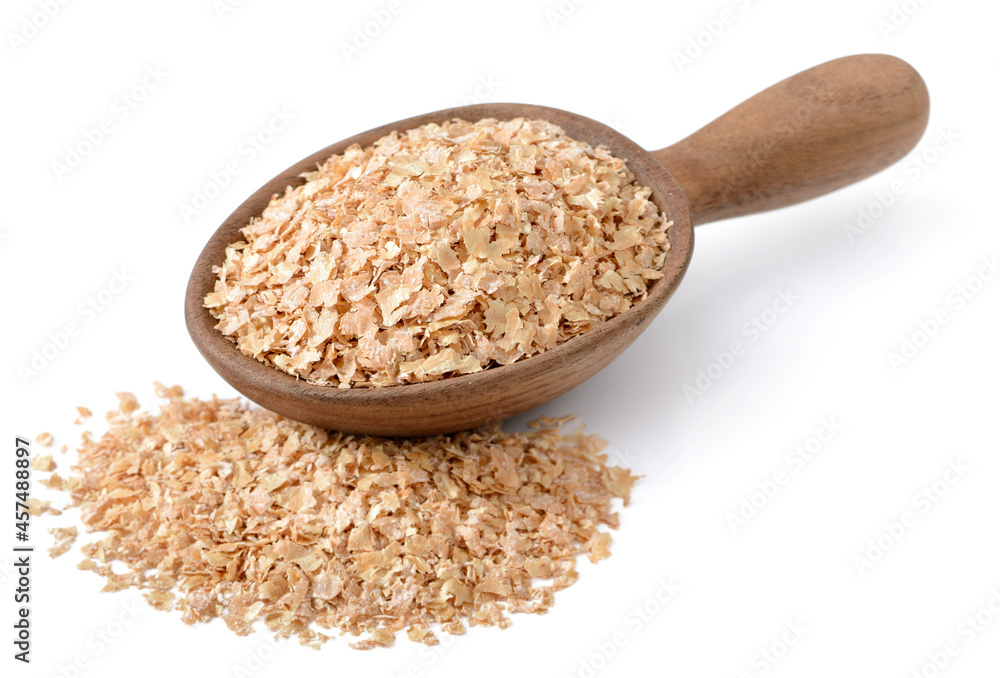 raw wheat bran in the wooden spoon, isolated on the white background raw wheat bran in the wooden spoon, isolated on the white background