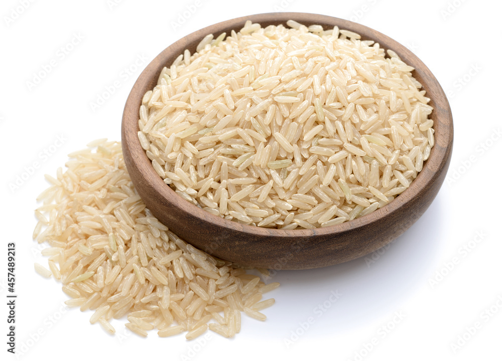 uncooked long brown rice in the wooden plate, isolated on white uncooked long brown rice in the wooden plate, isolated on white