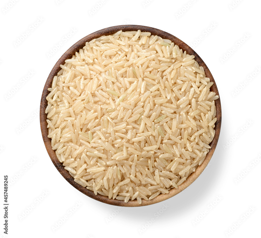 uncooked long brown rice in the wooden bowl, isolated on white, top view uncooked long brown rice in the wooden bowl, isolated on white, top view