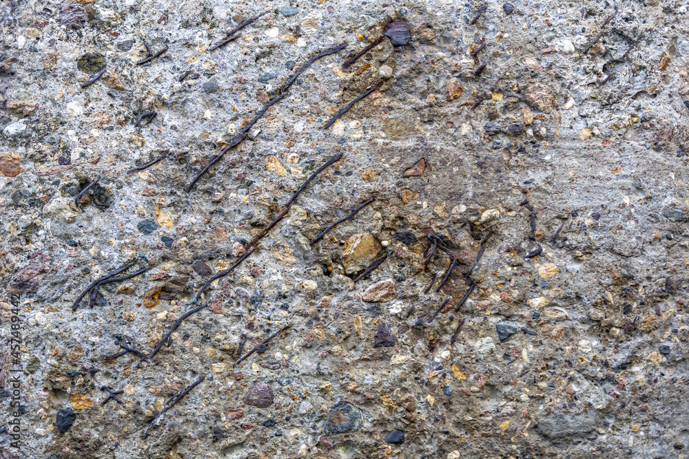 Textured surface of gray concrete wall with scratches and cracks Textured surface of gray concrete wall with scratches and cracks