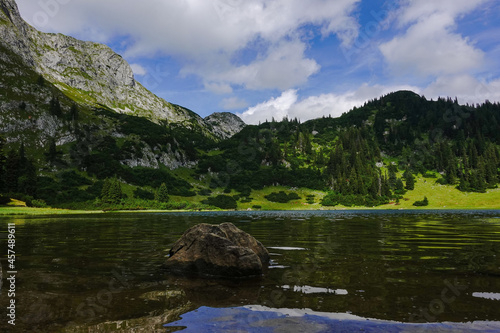 single rock in the water from a mountain lake with wonderful landscape