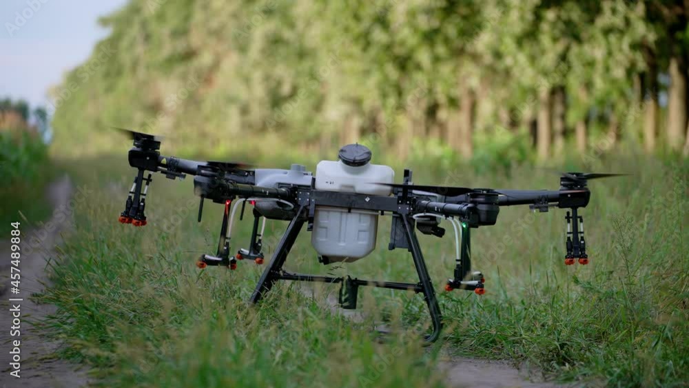 Agro copter works in the field, introduces 33p pesticides. Corn rye and wheat in the field. An agricultural drone aerial vehicle sprays a field at sunset. Agro copter works in the field, introduces 33p pesticides. Corn rye and wheat in the field. An agricultural drone aerial vehicle sprays a field at sunset.