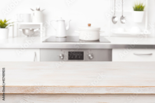 Empty wooden table with blur kitchen background and copy space