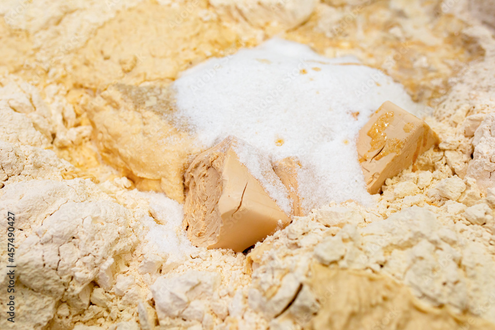 Dough ingredients: yeast, flour, sugar are ready for mixing in bakery Dough ingredients: yeast, flour, sugar are ready for mixing in bakery