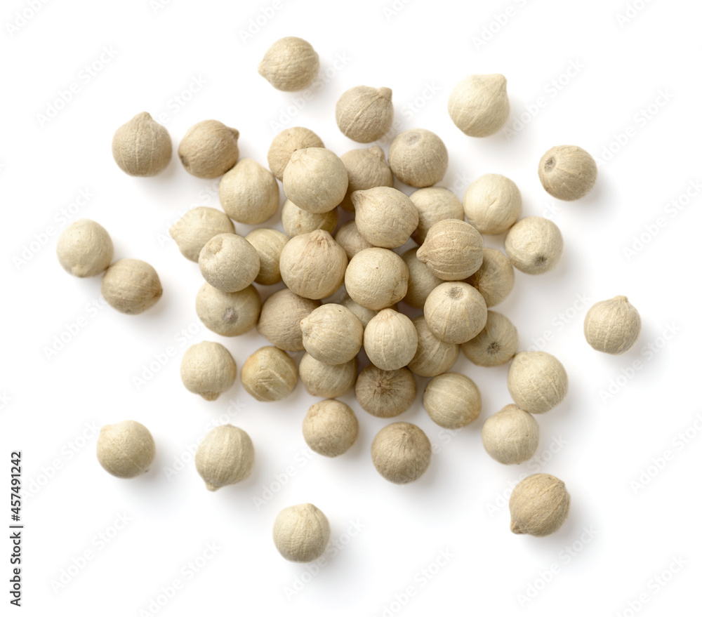 closeup of whole white peppercorns isolated on the white background, top view
