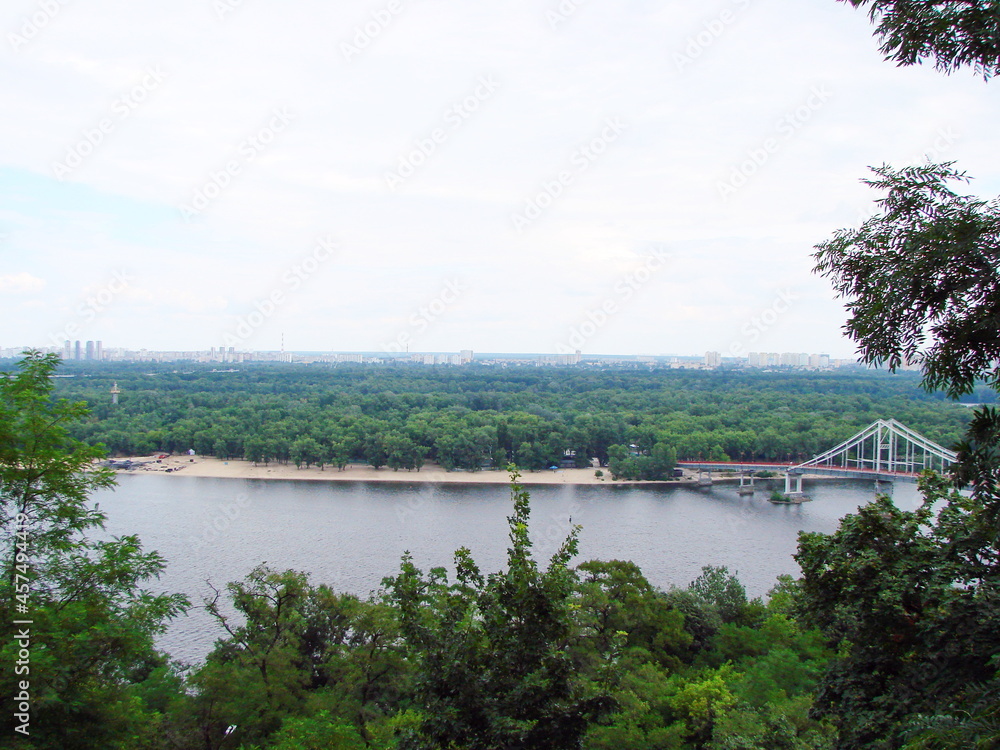 Unsurpassed landscape of the Dnieper surrounded by dense greenery almost in the center of the green city.