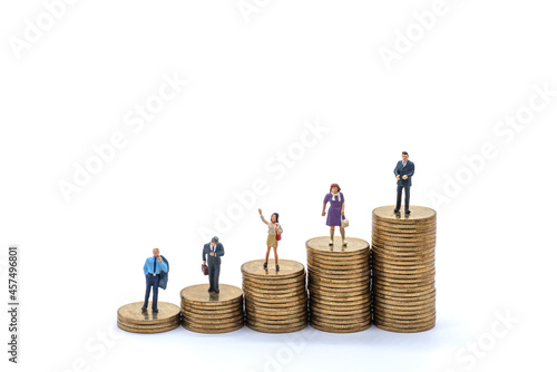 Business, Money Investment and Planning Concept. Group of Businessman and businesswoman miniature figure people figure standing on stack of gold coins on white background. photo