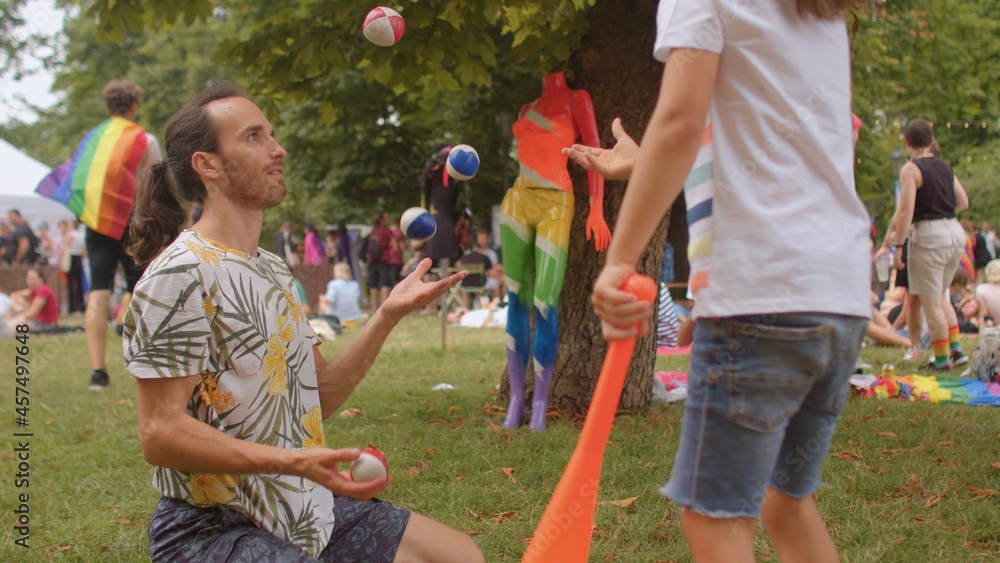 Dexterity training male teacher shows his skills in the camp. Juggling