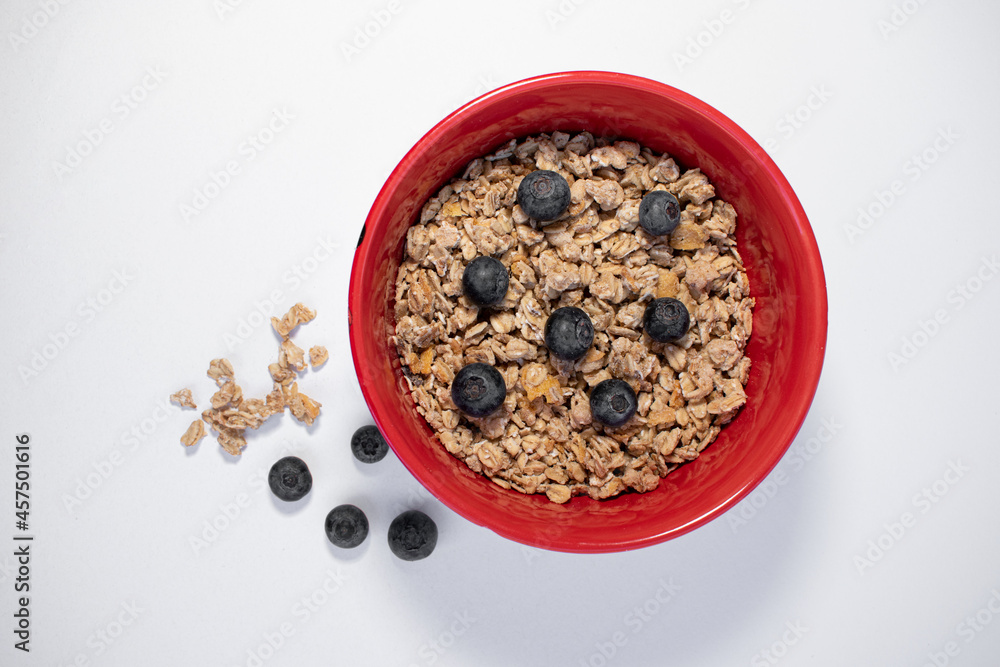 red bowl with cereals and blueberries red bowl with cereals and blueberries