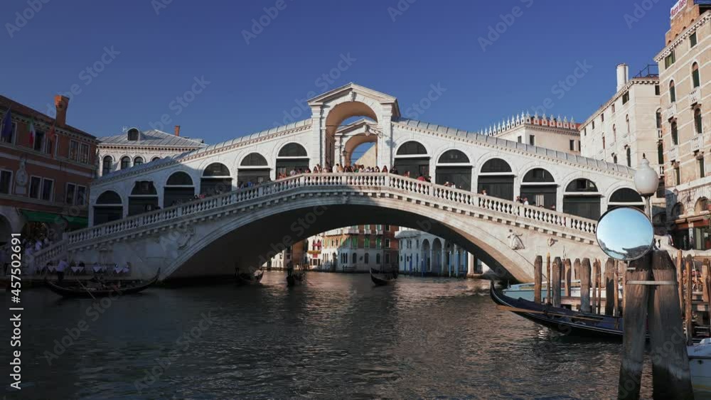 Night view of the bridge Rialto on Grand canal famous landmark panoramic view Venice Italy with gondola boat in the water. Night view of the bridge Rialto on Grand canal famous landmark panoramic view Venice Italy with gondola boat in the water.