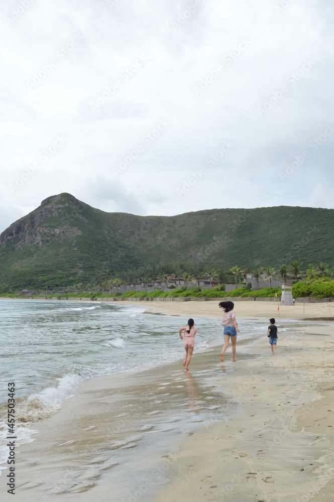 Kids playing and running on the shore of private beach resort in Con Dao Islands, Vietnam. Kids playing and running on the shore of private beach resort in Con Dao Islands, Vietnam.
