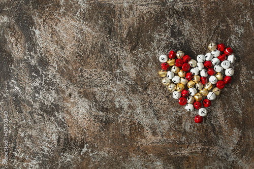 colourful jingle bells on  grey stone surface photo