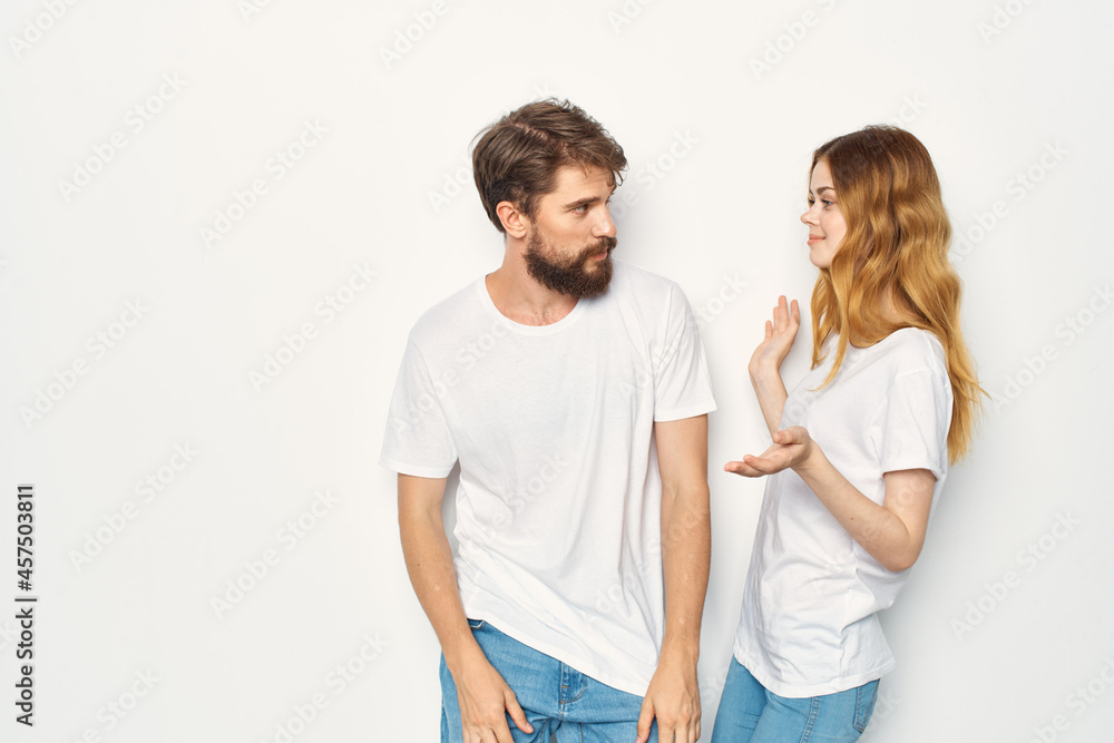 cheerful young couple in white t-shirts embrace friendship lifestyle cheerful young couple in white t-shirts embrace friendship lifestyle
